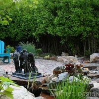 dry stream and sculpture in garden