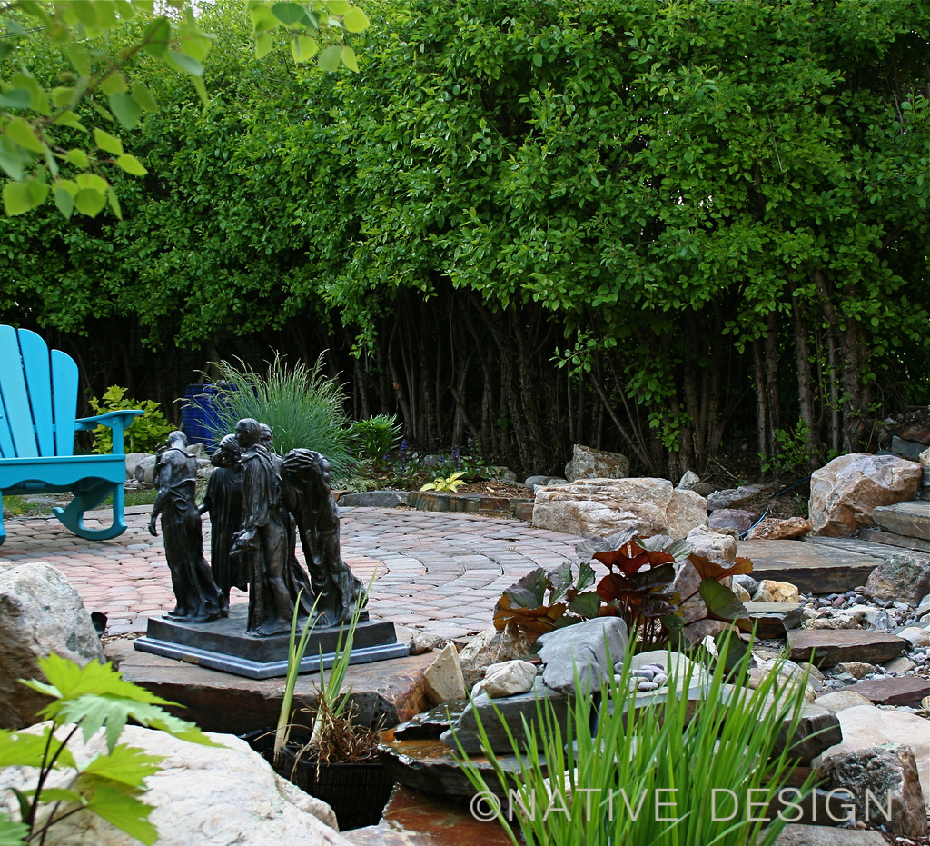 dry stream and sculpture in garden