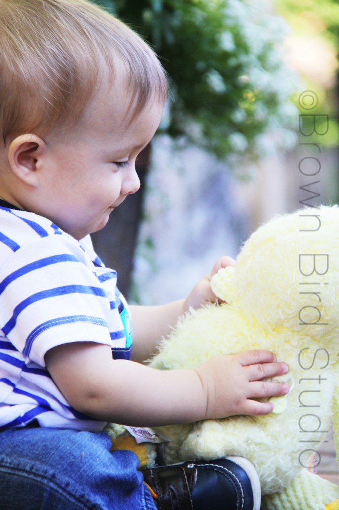 baby with stuffed duck