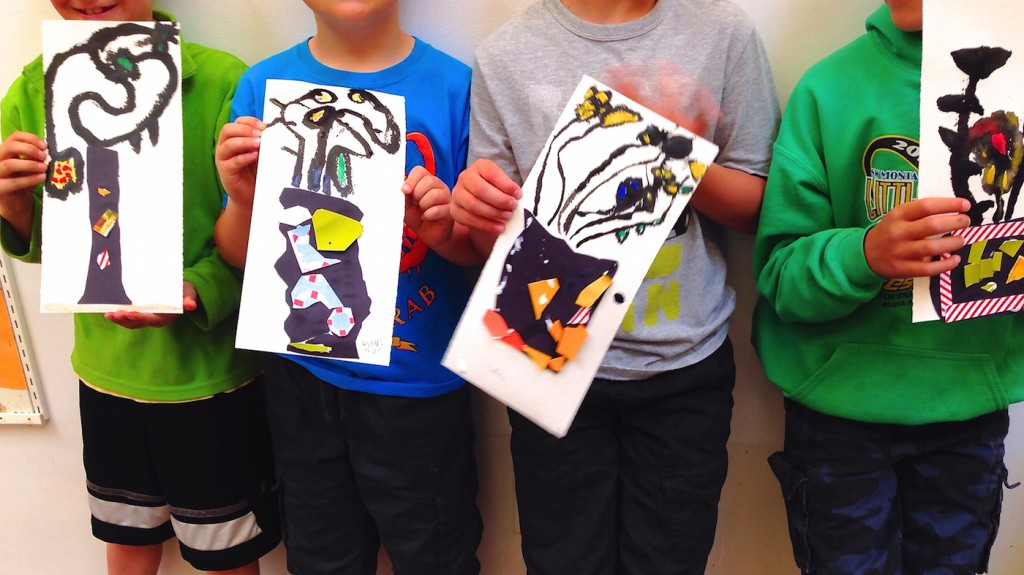 Boys holding their artwork